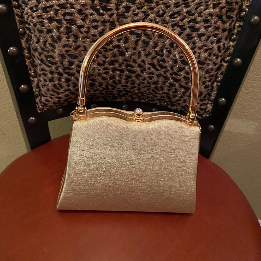 Super cute small gold hand held cocktail purse.